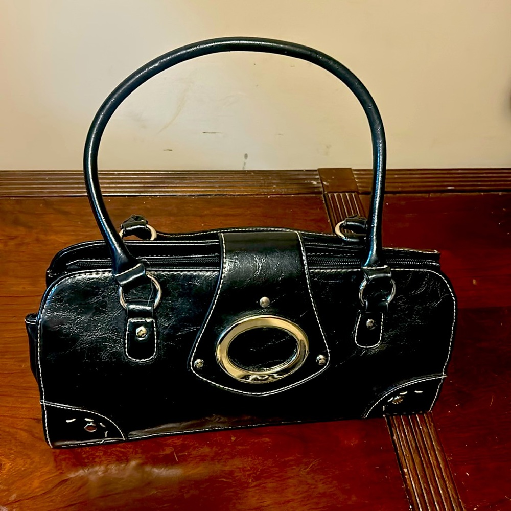 A black purse 15 inches wide and 10 inches deep